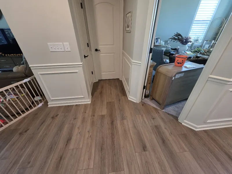 Hallway openings trimmed with white box moulding and chair rail, panels sized to fit each wall section between doorways
