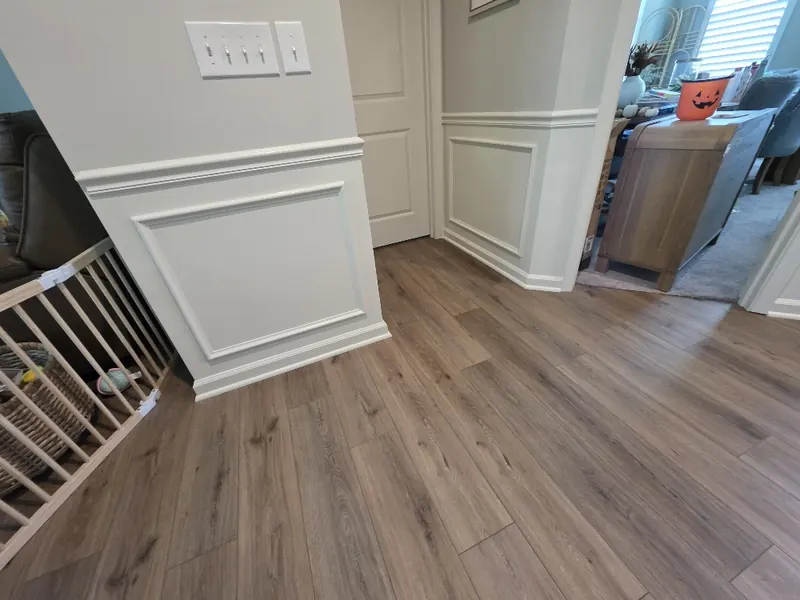 Outside wall corner where the white chair rail and box moulding panel wrap cleanly around the corner