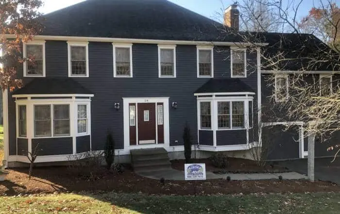 Two-story home with dark gray siding and white trim.