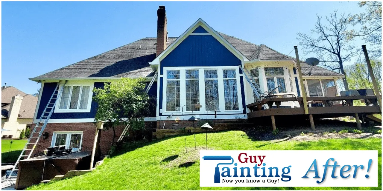 Brick home exterior after repainting, with new dark trim