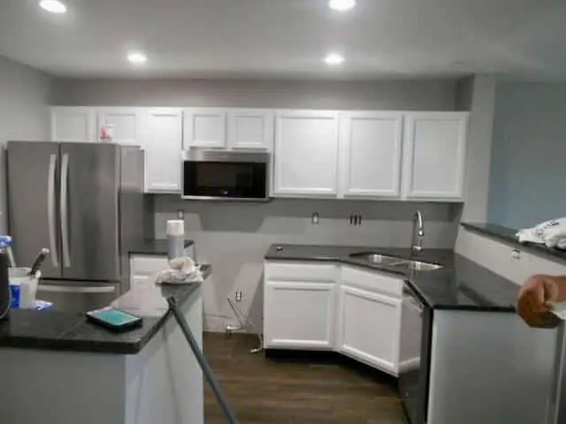 Shaker kitchen cabinets painted antique white with dark granite countertops