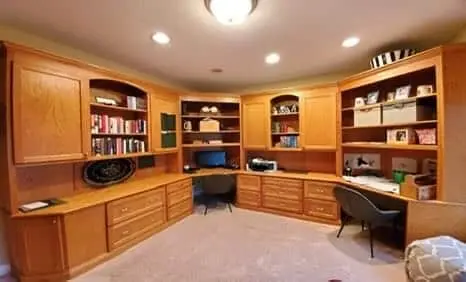 Before: large gray kitchen island with corbels and glass-front cabinets on hardwood floors