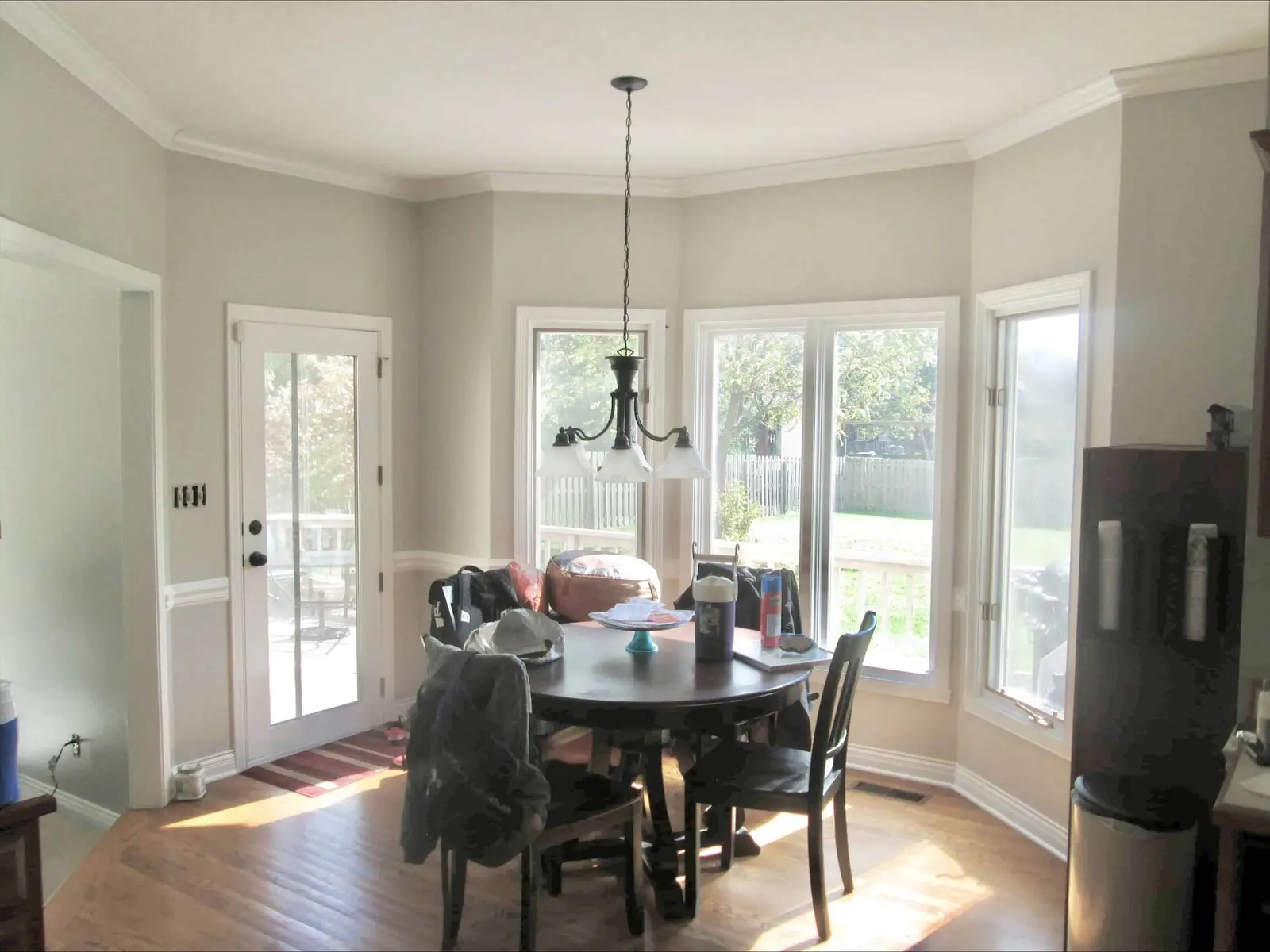 After: breakfast nook and dining area with dark stained trim painted white