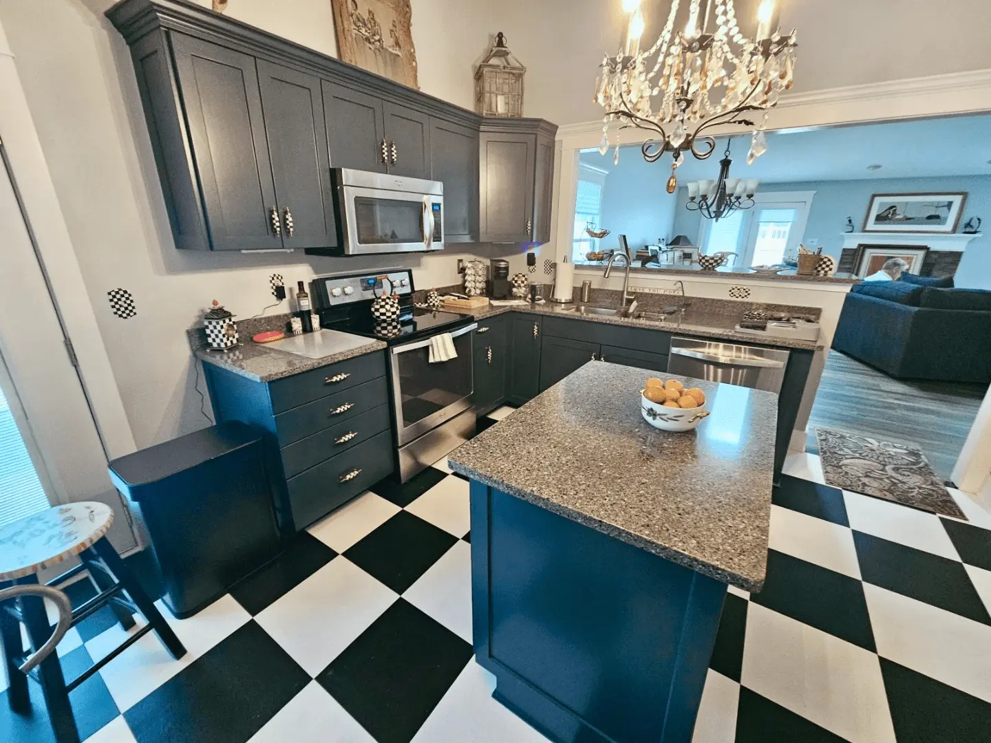 Kitchen cabinets and island painted sapphire blue, with a black-and-white checkered floor