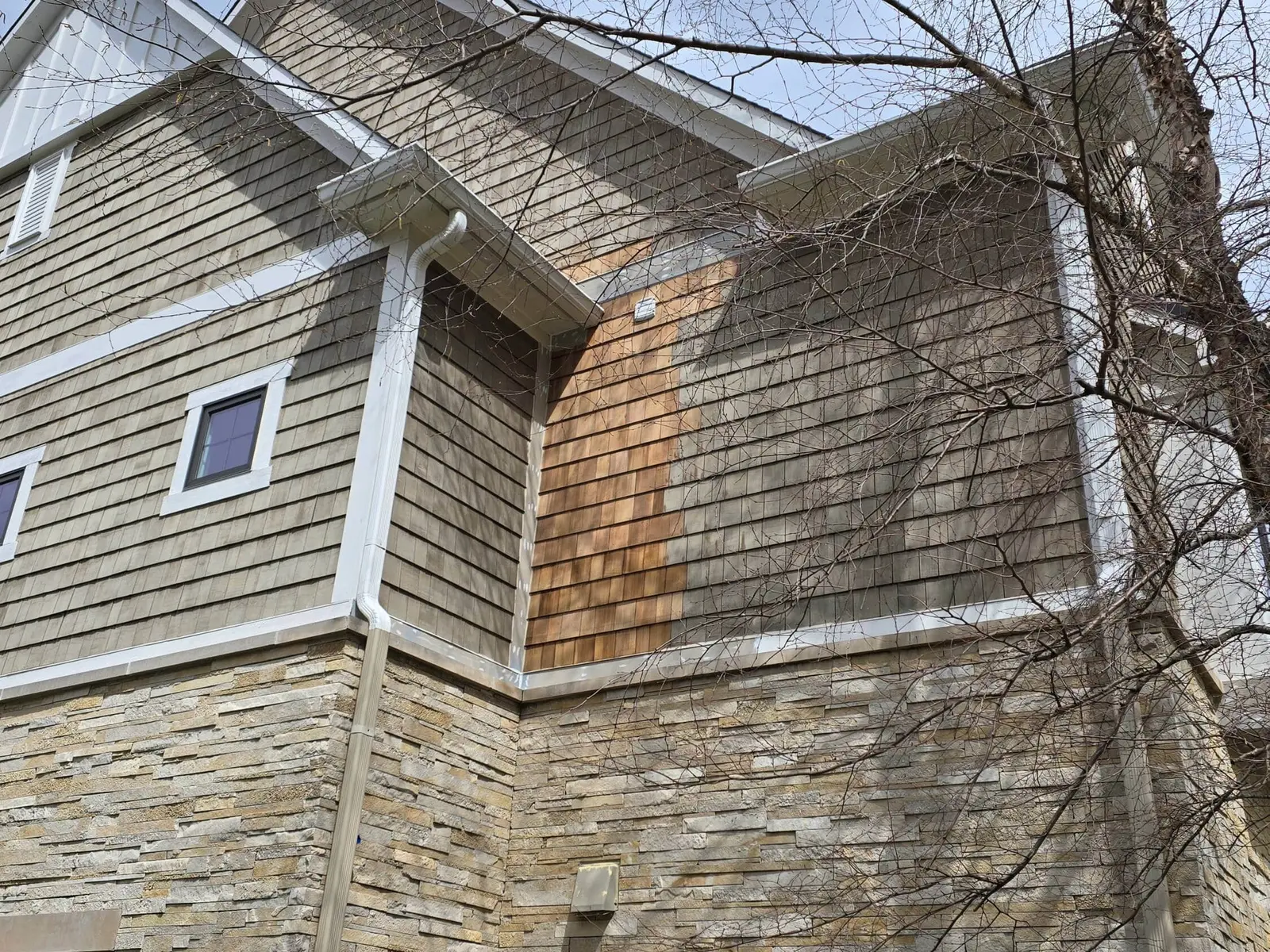 Newly replaced section of cedar shingle siding, seen from above
